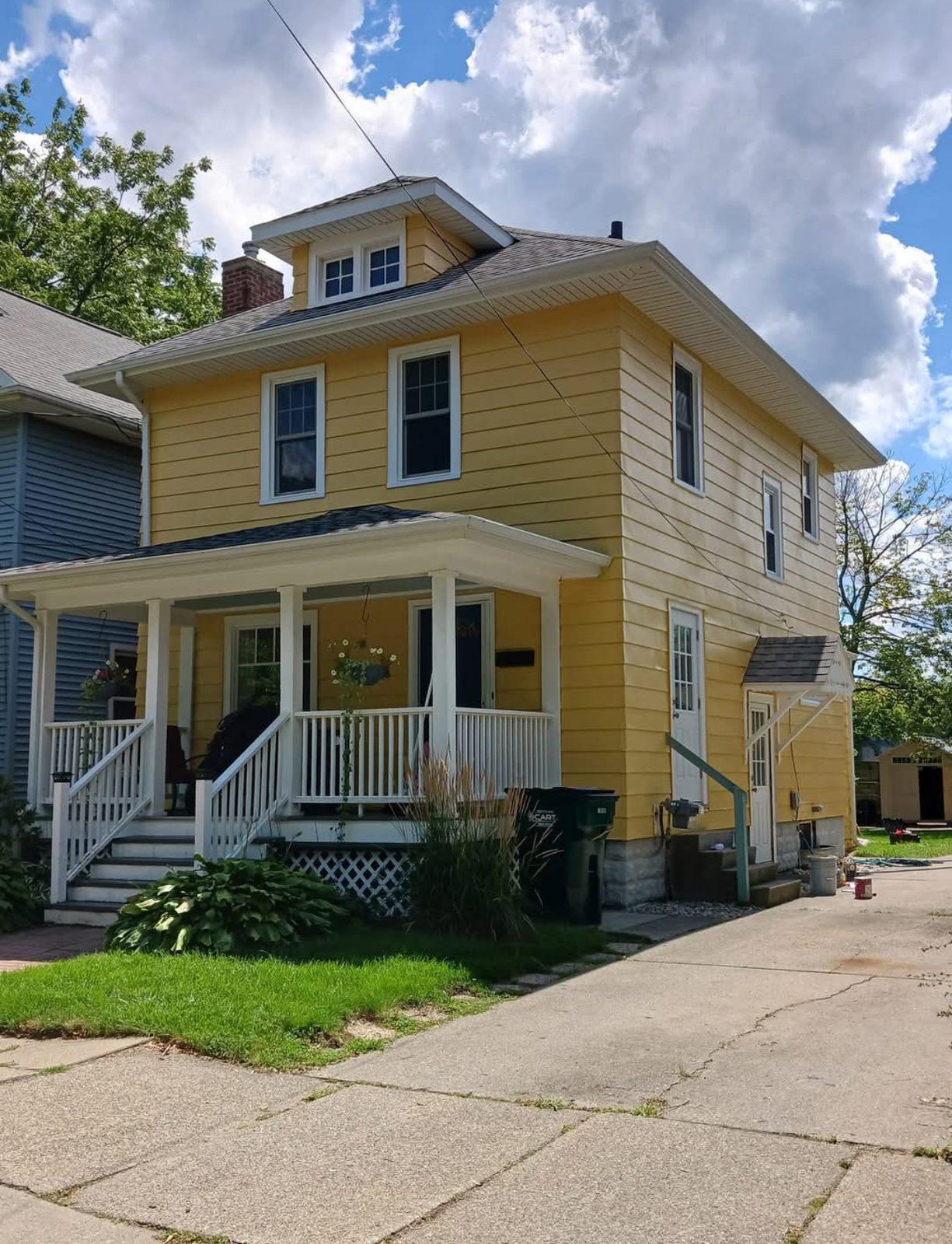 Two-storey house exterior after a full repaint, front elevation and porch