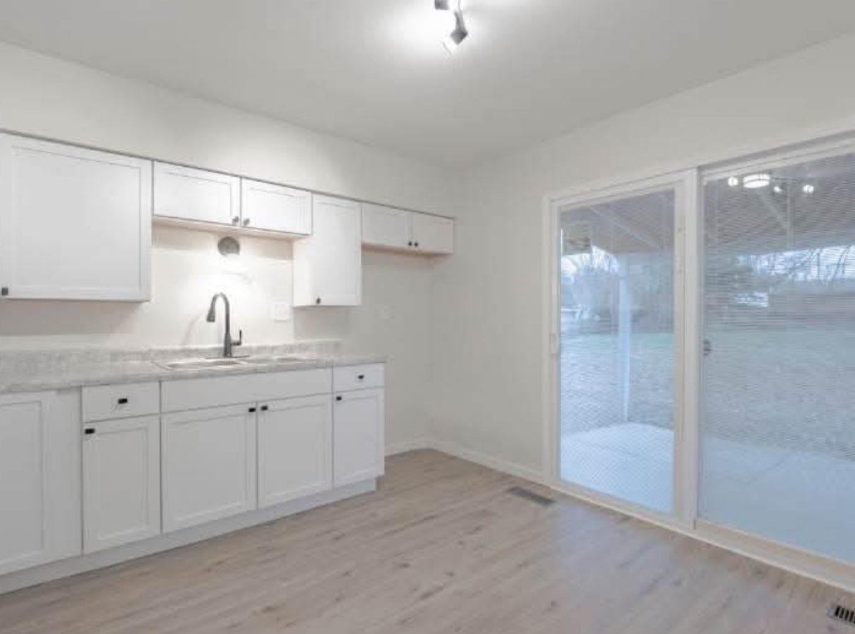 Finished kitchen with white shaker cabinets and new worktops, ready for handover