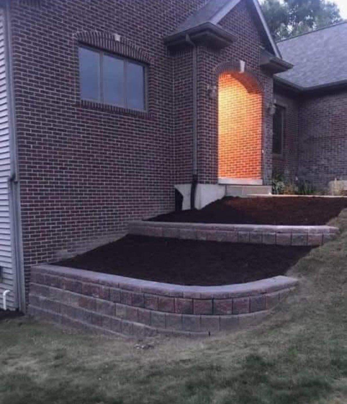Brick paver steps and a retaining edge built up to a front entrance