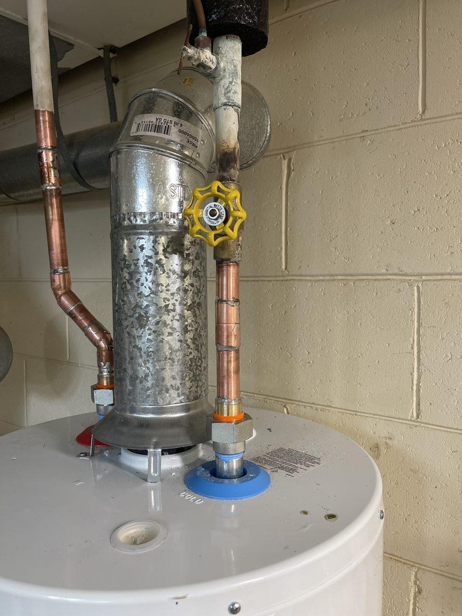 Newly installed water heater with fresh copper pipework and a shut-off valve