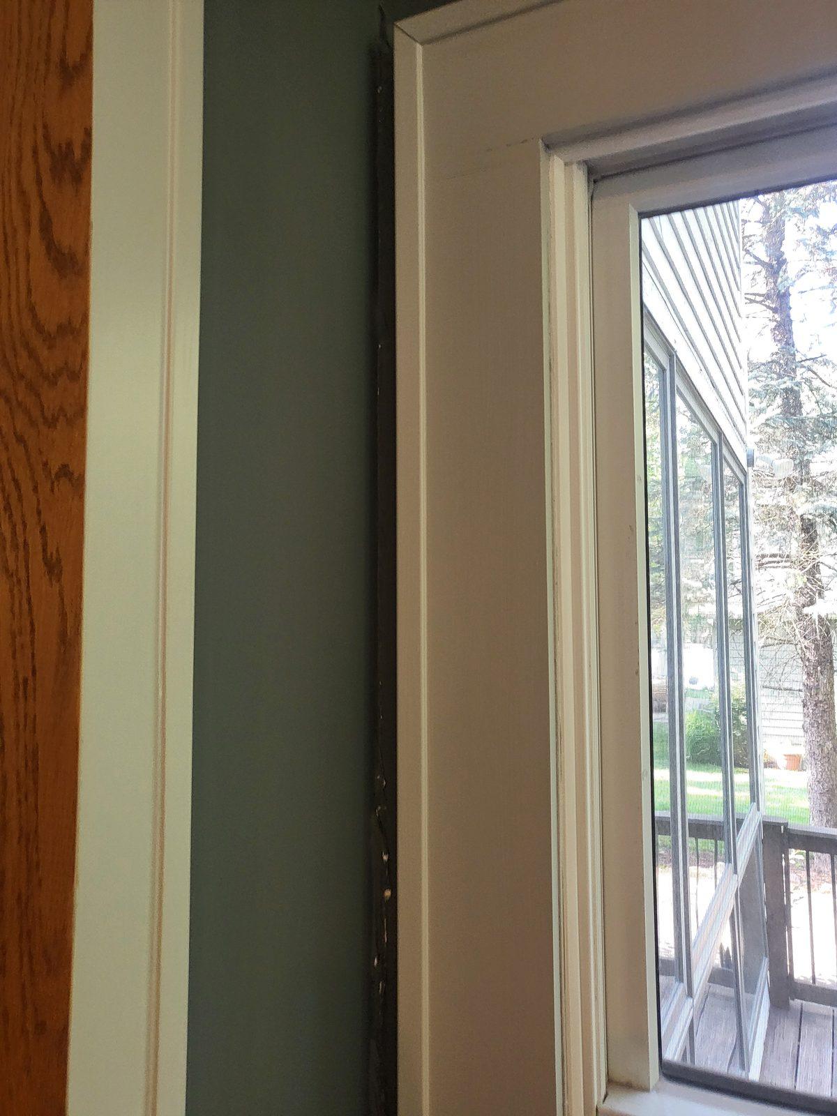 Door reveal and casing showing a dark separation line where water had been tracking down