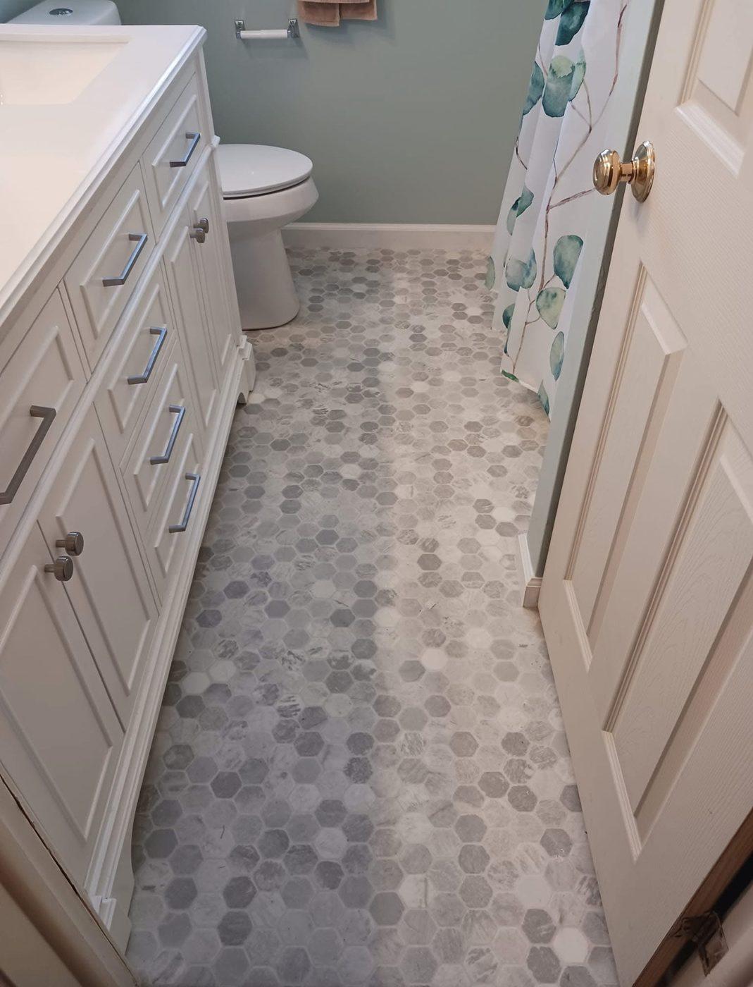 Bathroom with a new hexagonal tiled floor and vanity unit